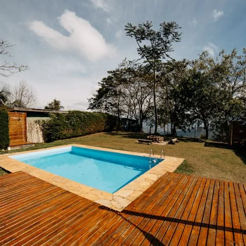 Pool area with wooden deck surround